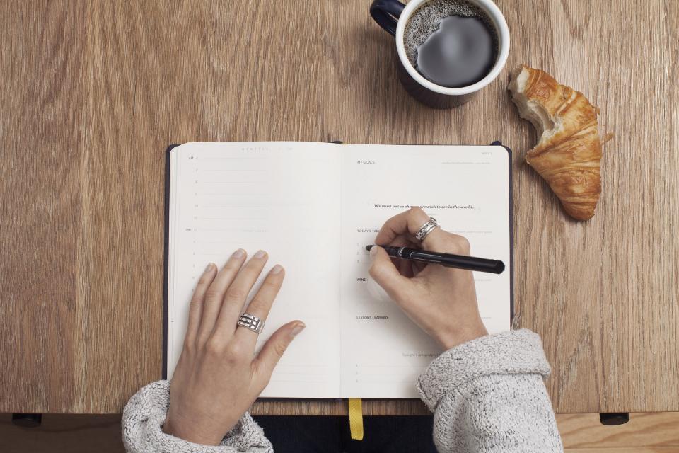 Creator writing a script in a notebook for the scripting hooks article