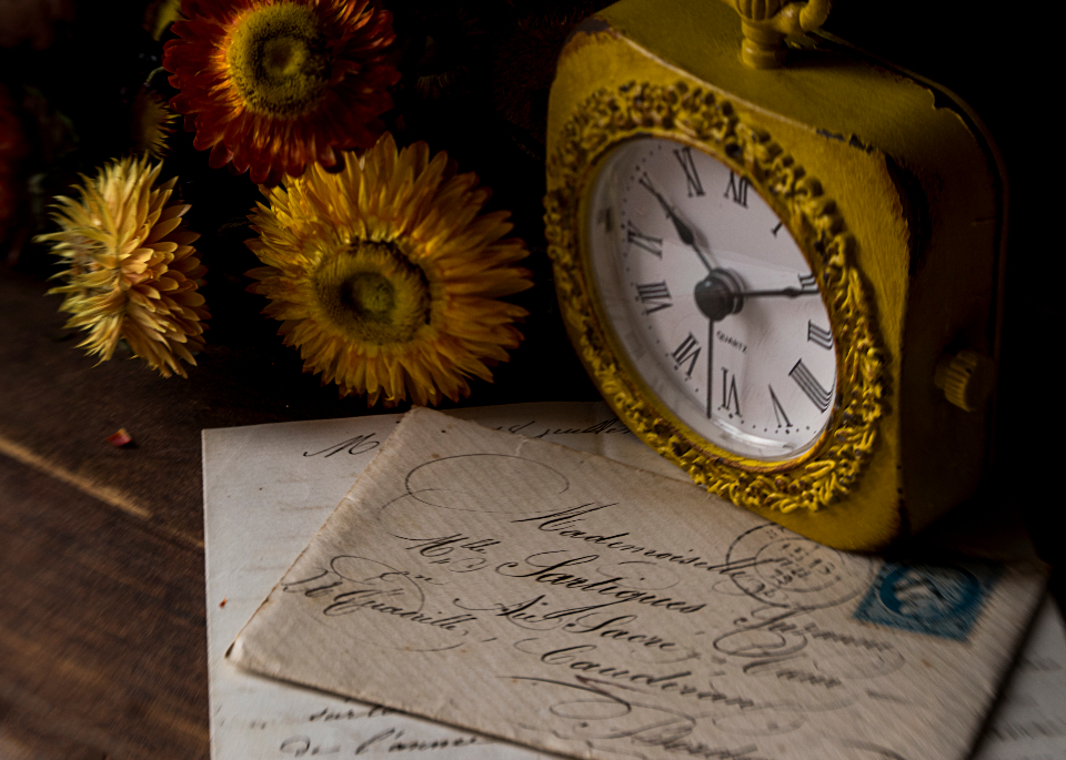 An antique clock beside an old handwritten letter, symbolizing the cost of delaying digital adoption