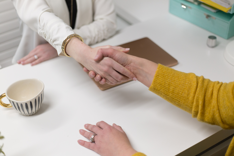 Business handshake representing a parent company and its subsidiary brands